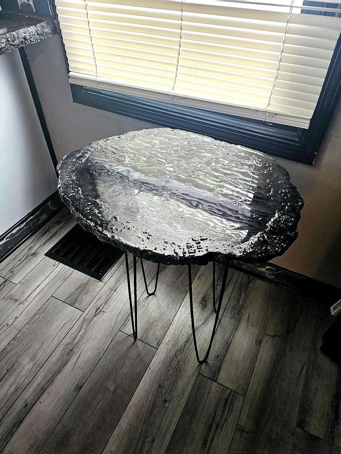 Concrete table with embedded stone and resin